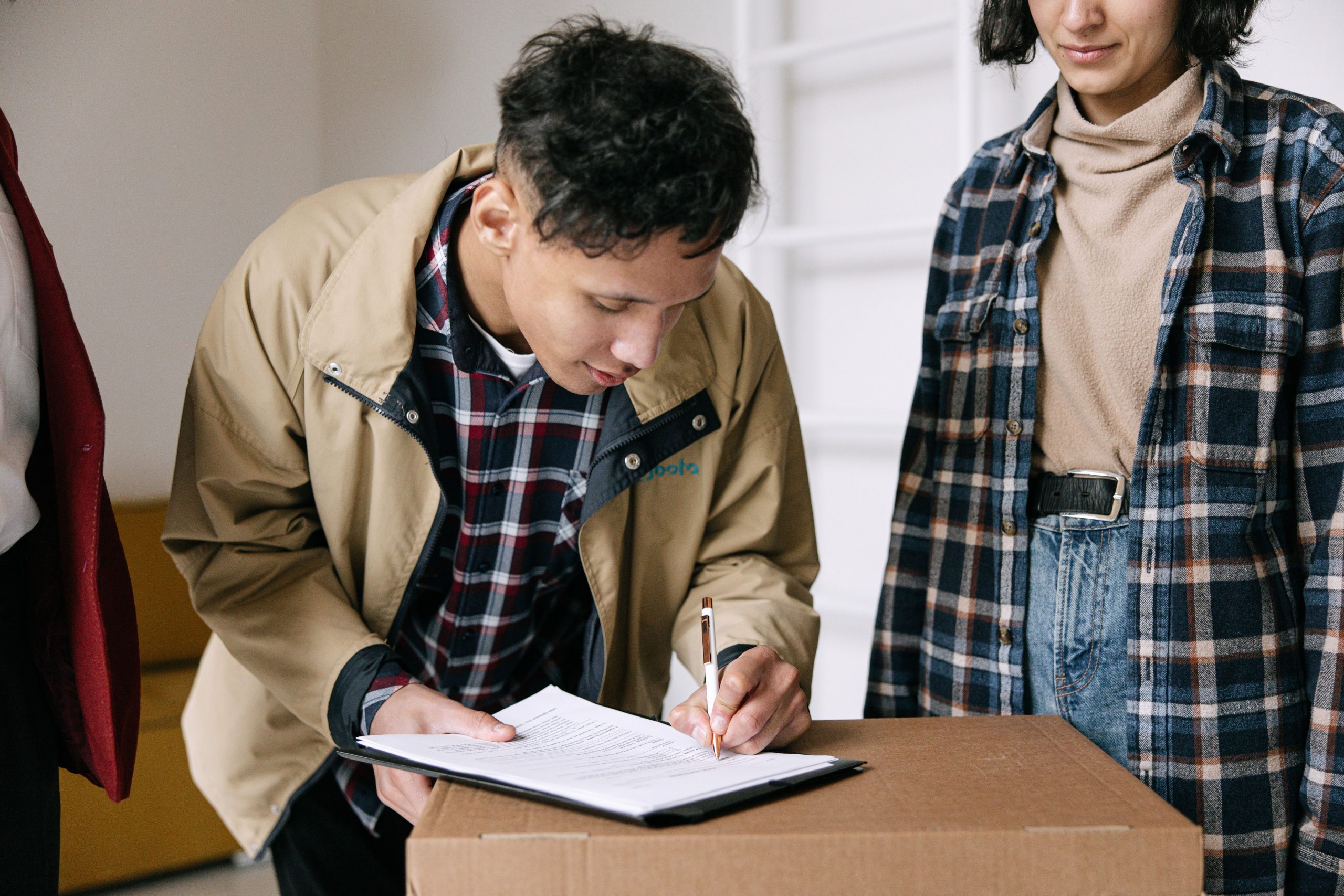 Jeunes adultes signant documents lors de déménagement